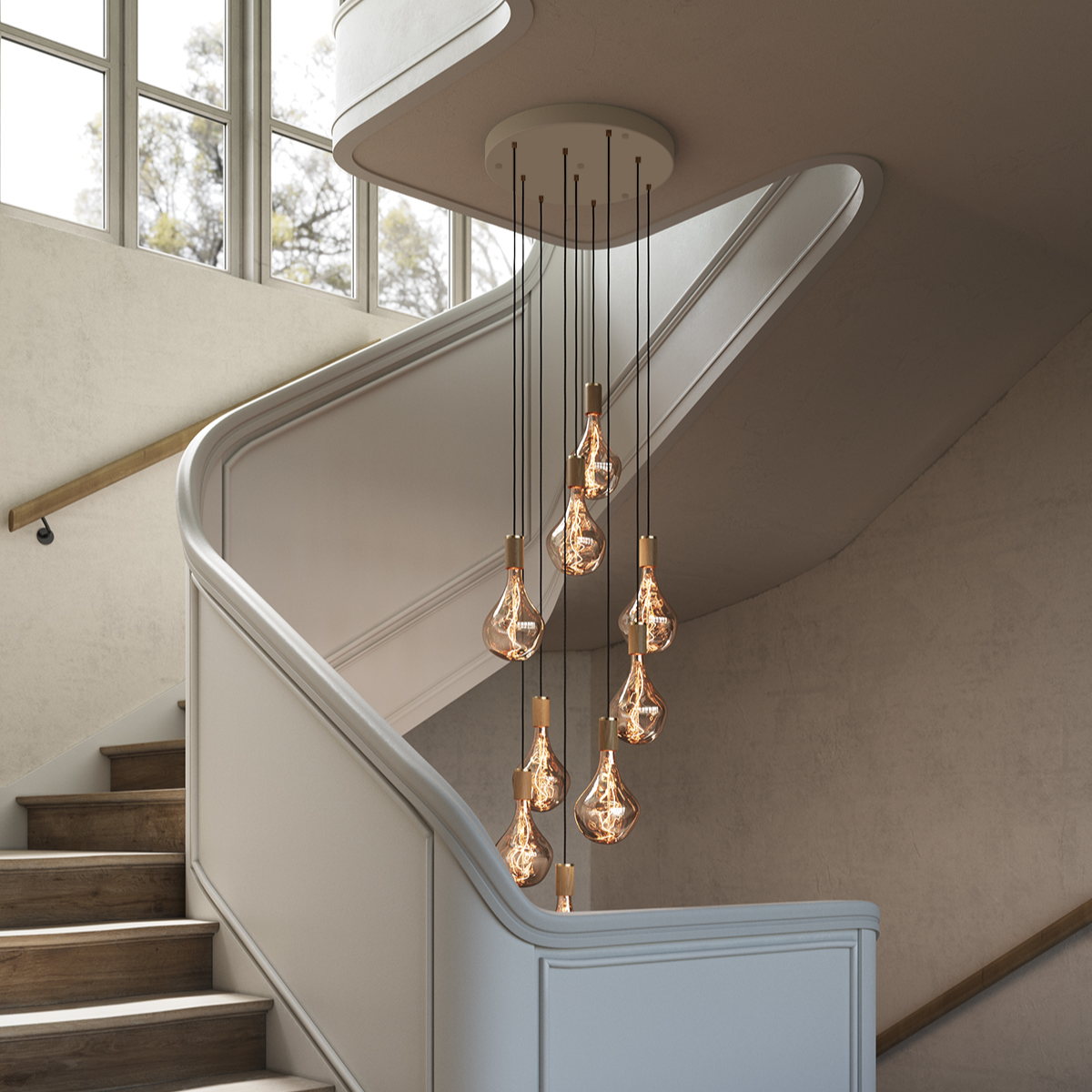 Tala Nine Pendant in Oak with Voronoi II bulbs, installed over a staircase