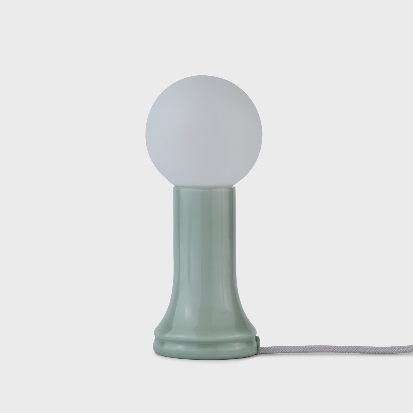 Tala Shore table lamp in Sea Green glass lit, showing Dim to Warm glow