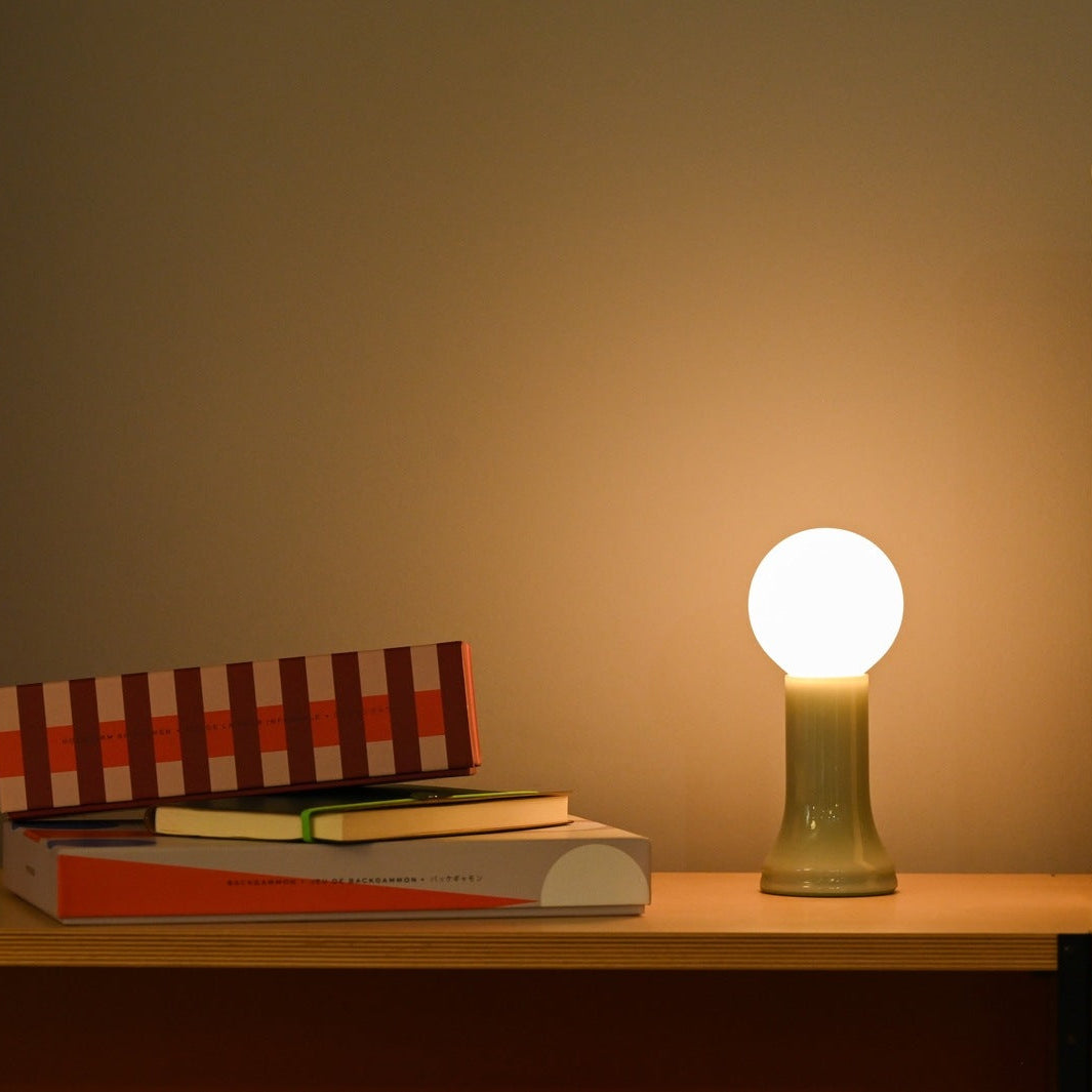 Tala Shore table lamp in Sea Green glass in a warm holiday interior