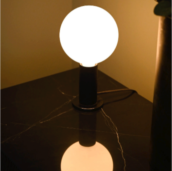 Tala Knuckle table lamp with Sphere IV bulb in Oak, styled in a holiday interior scene