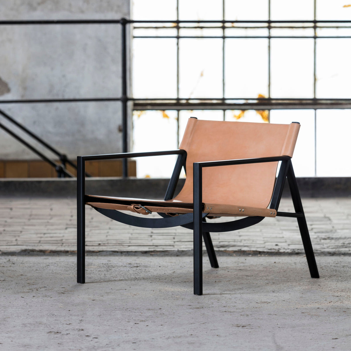 Bent Hansen Tension Lounge Chair in natural saddle leather, styled in an interior setting, steel and leather