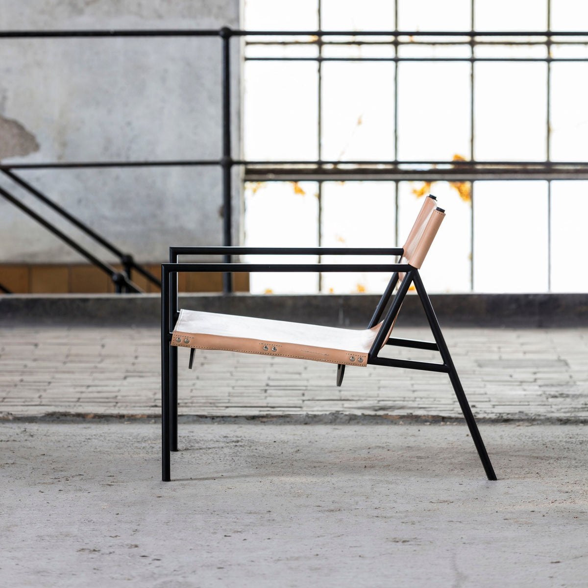 Bent Hansen Tension Lounge Chair in natural saddle leather, styled in an interior setting, steel and leather