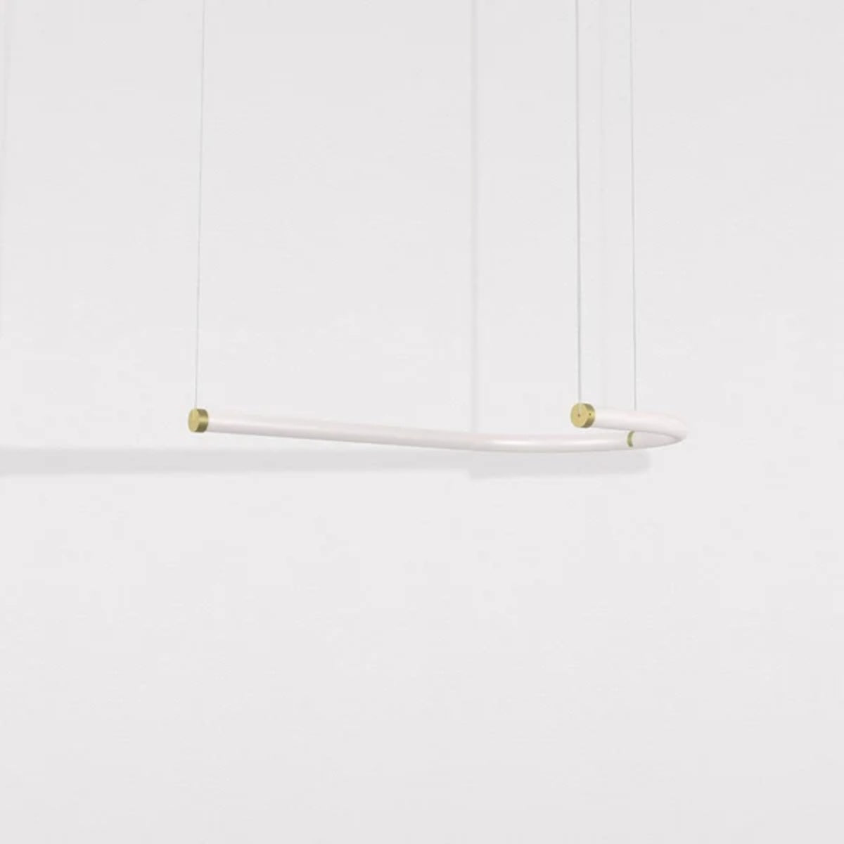 Petite Friture Unseen J pendant light in brass and white glass, hung horizontally