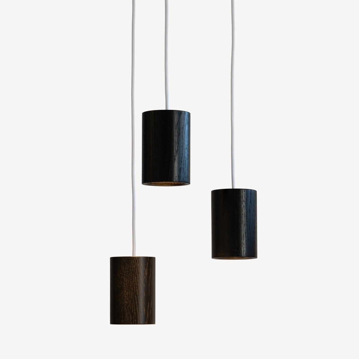Case Solid Three Pendant Cluster in Black Stained Oak, staggered cylinders, black stained solid oak
