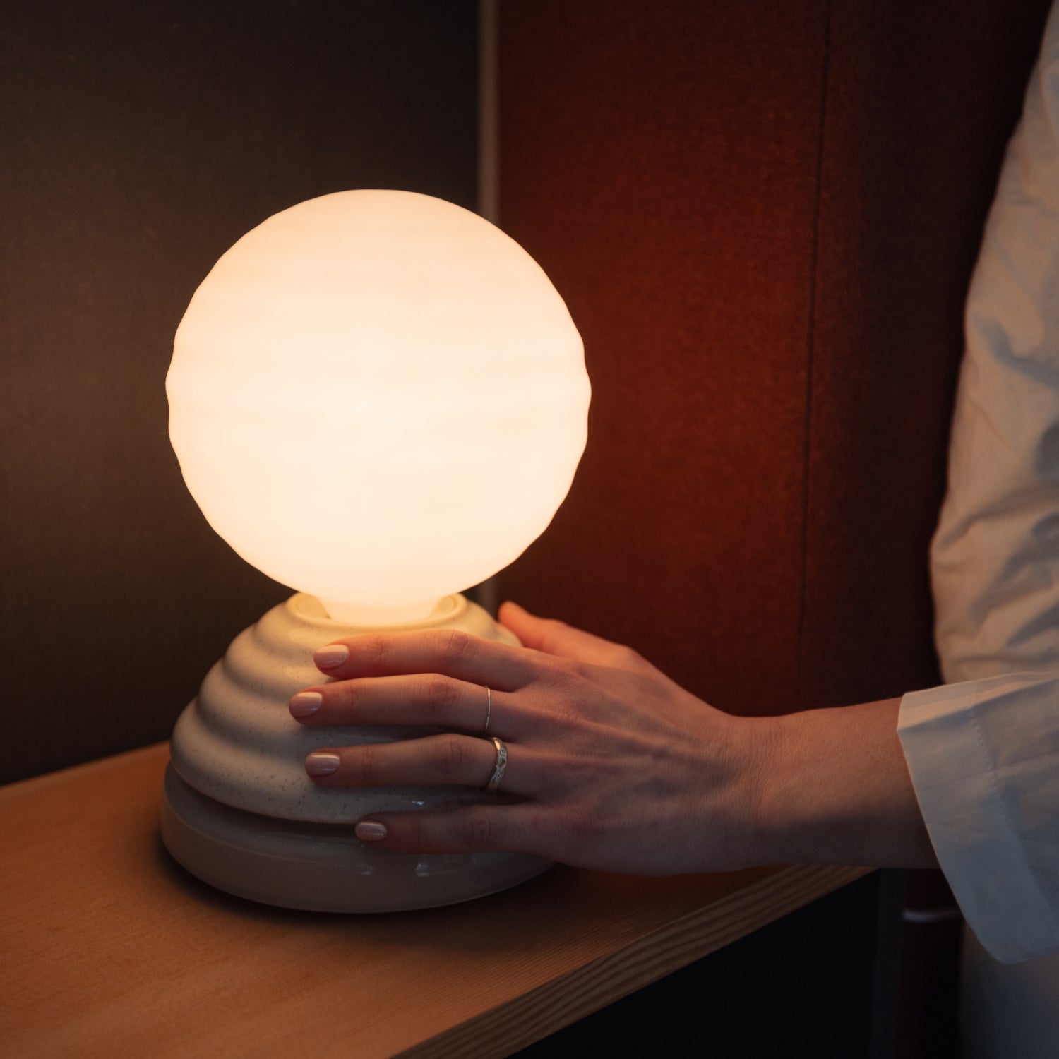 Wake Sleep Light in Pebble White by Tala — table lamp, angled side view