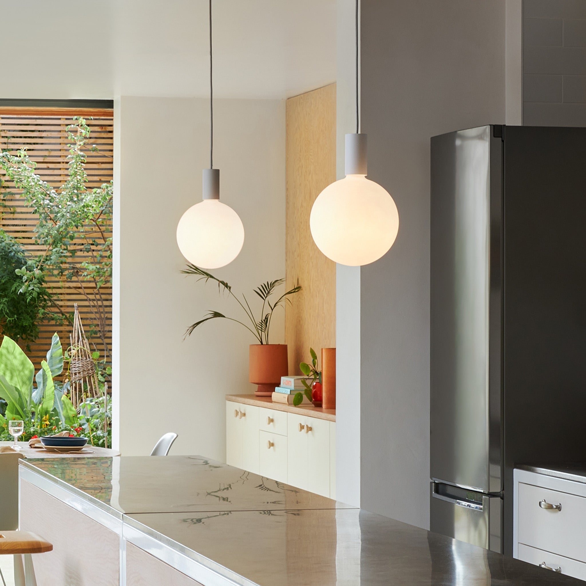Tala Alumina Single Pendant with Sphere V bulb, hanging installation view