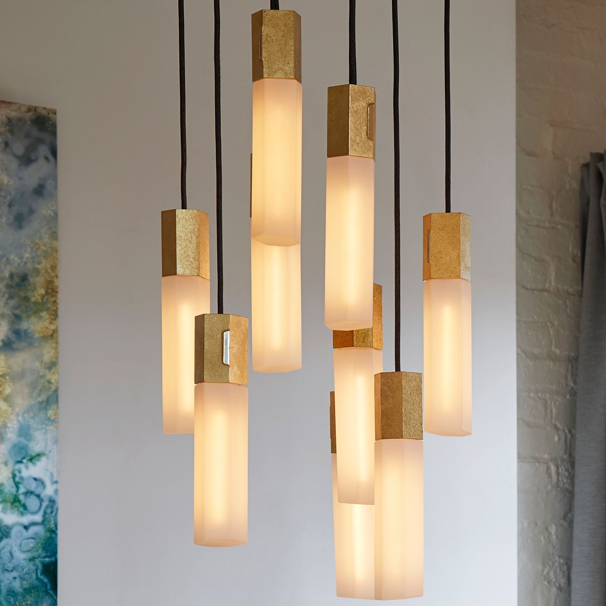 Basalt Nine Pendant by Tala in Brass, close-up of the exposed Tala logo cast mark