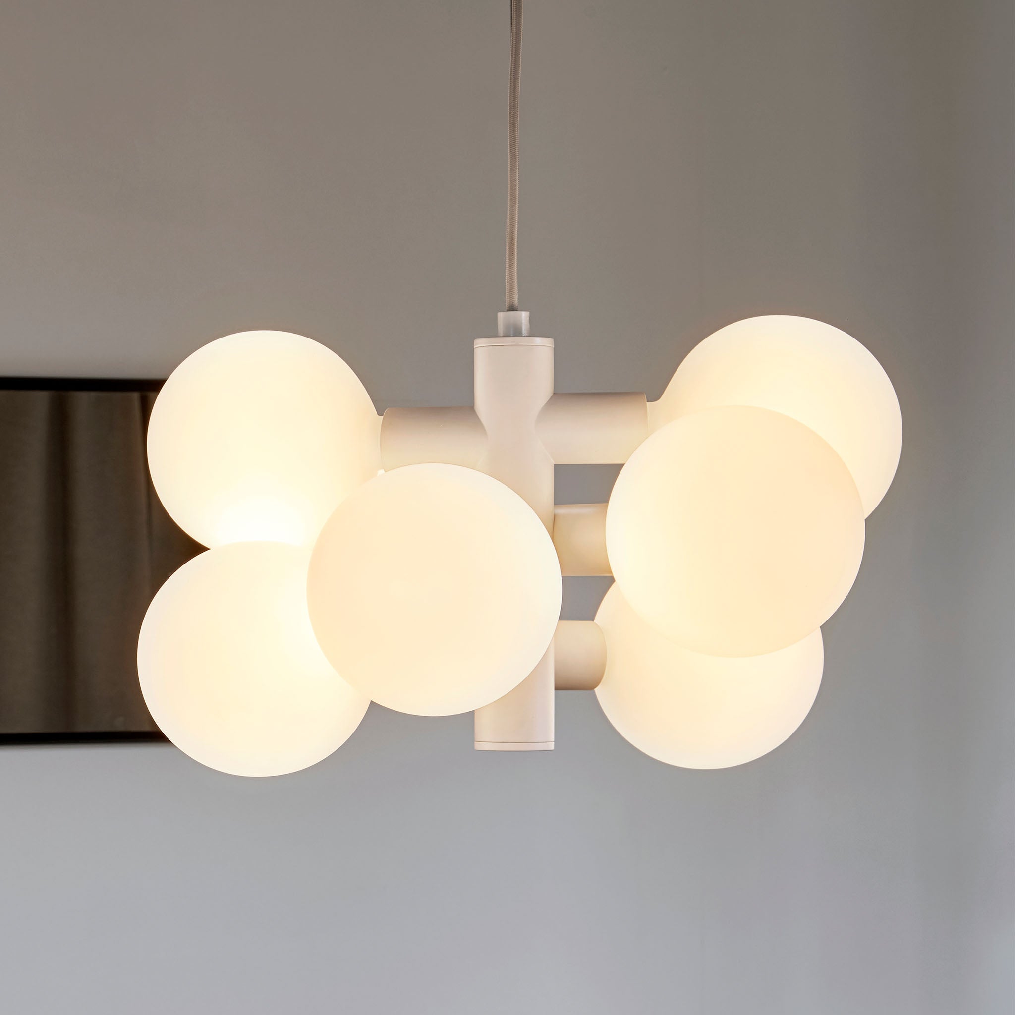 Side profile of the Echo Chandelier showing intersecting steel cylinders