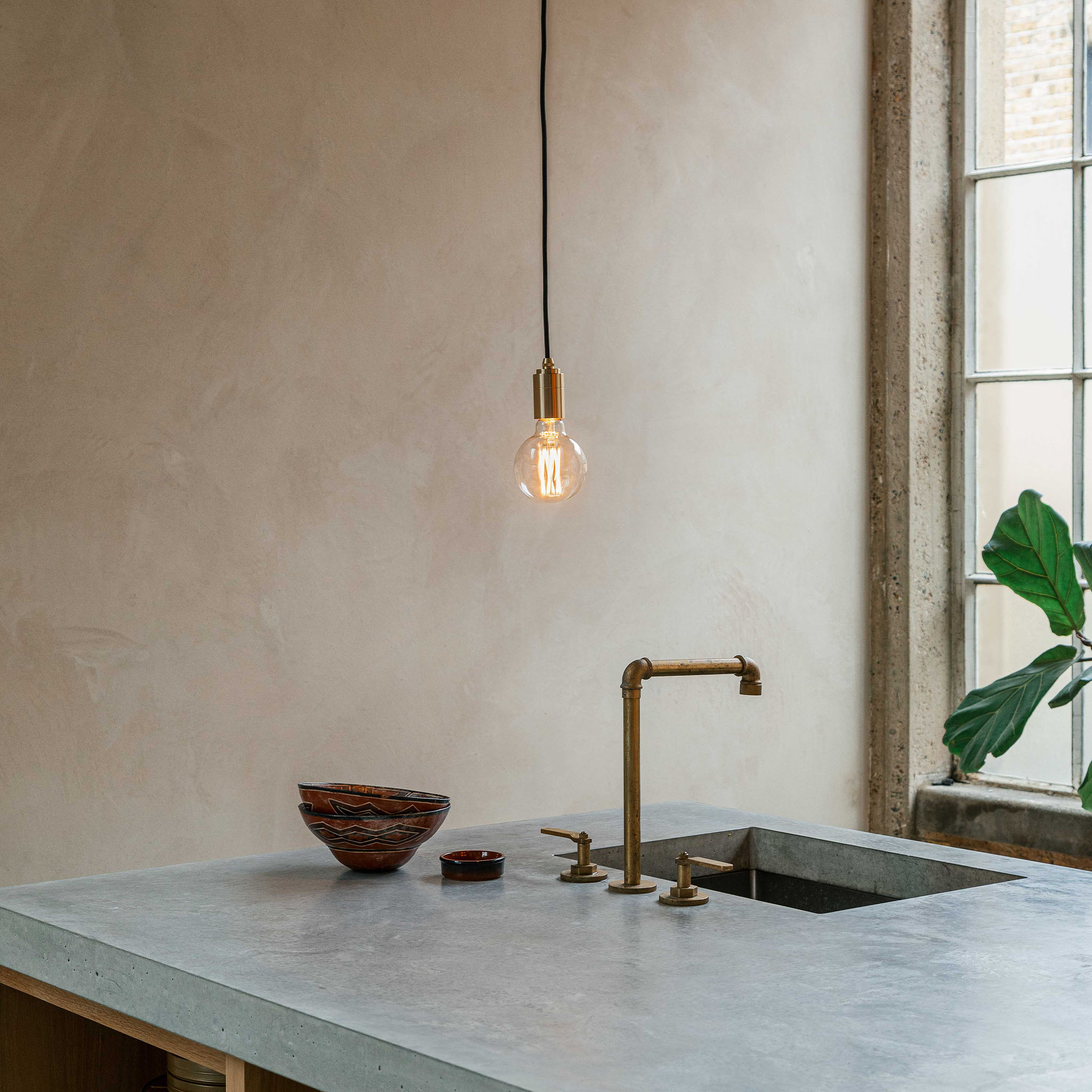 Elva Pendant Light in Brass, Non-Tinted, shown in a kitchen setting