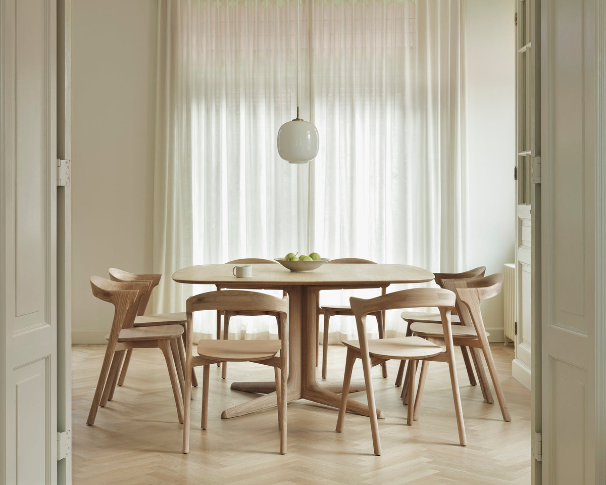 Ethnicraft Corto Dining Table in oak with oak dining chairs, styled in a dining room, solid oak