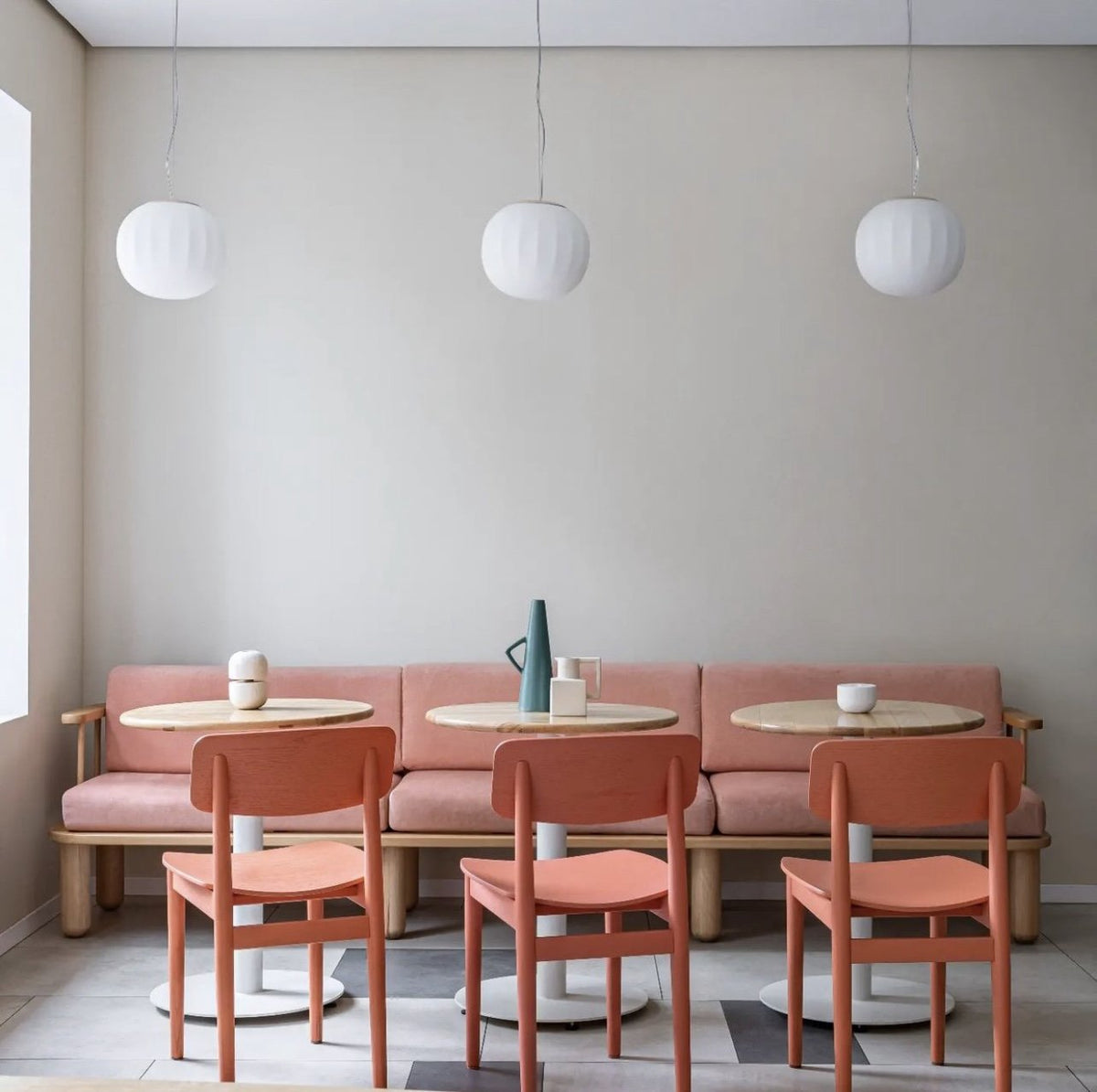 Luceplan Lita Pendants in a row over cafe tables with terracotta chairs