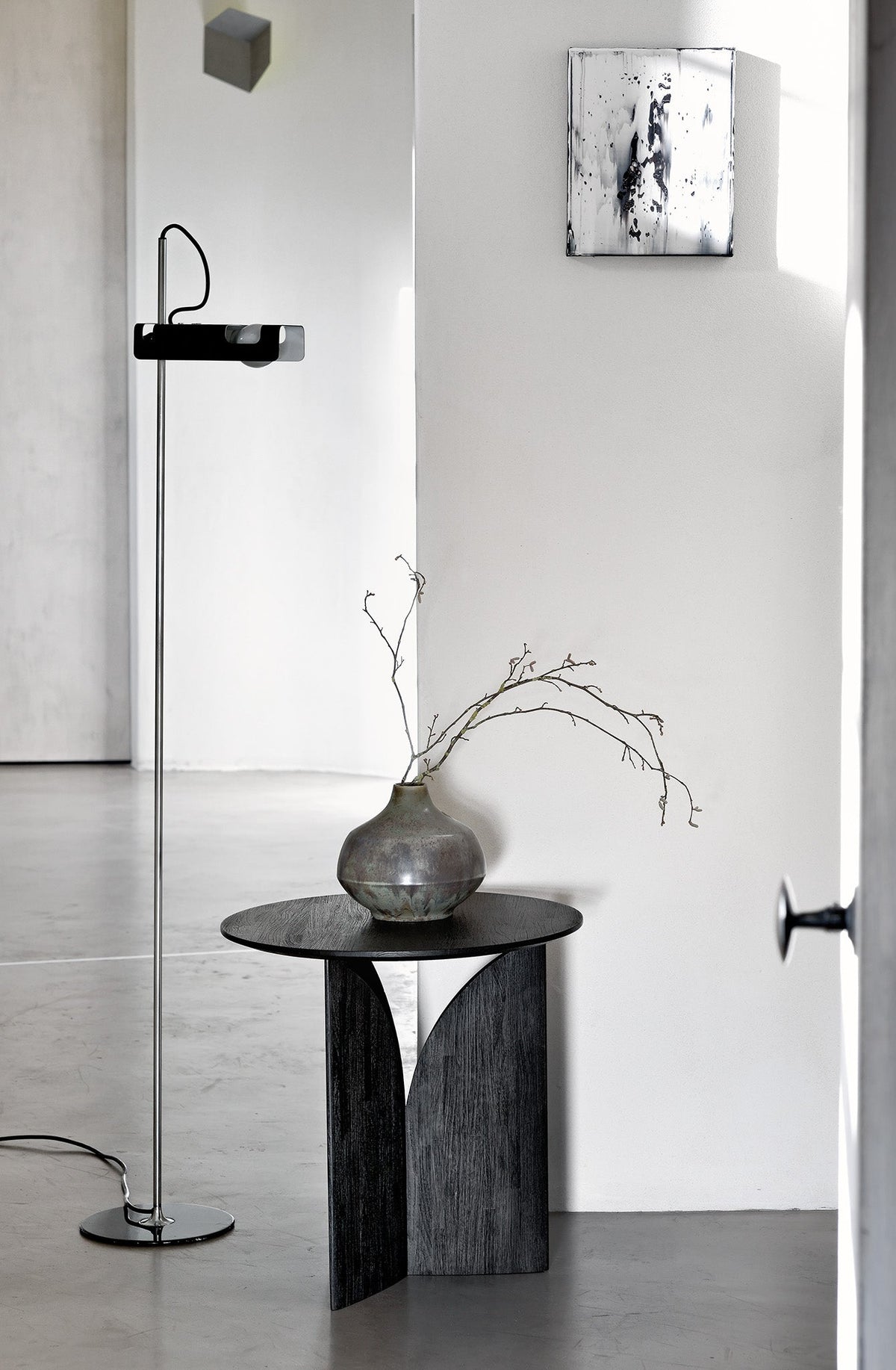 Ethnicraft Fin Side Table in Teak Black, styled in an interior setting, black-tinted FSC-certified solid teak