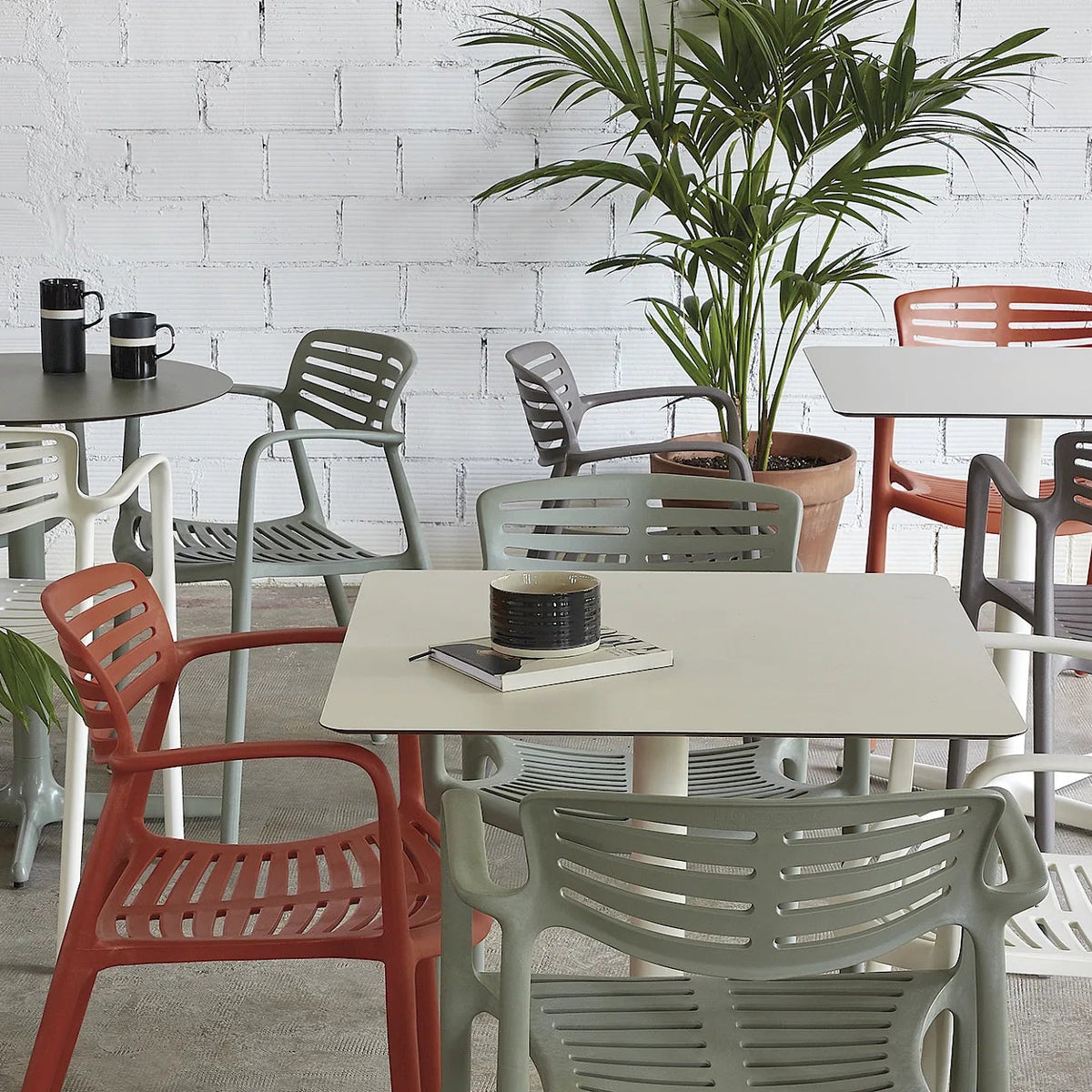 Resol Toledo Table in Ivory with Toledo Aire chairs, styled on a terrace, painted aluminum and HPL