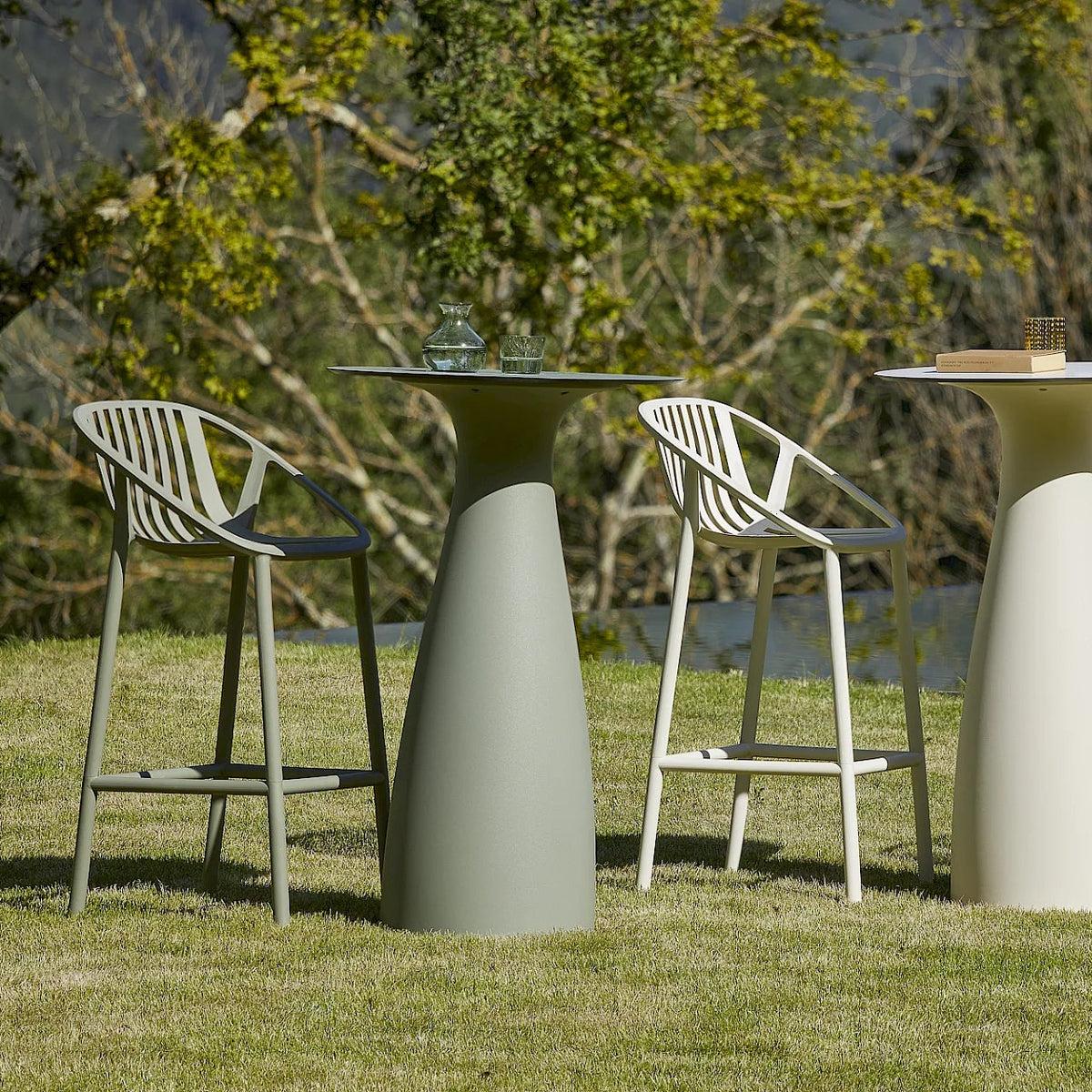Resol Bini Bar Stools in Green Grey and Ivory at Baobab bar tables, styled in a garden, polypropylene with fiberglass