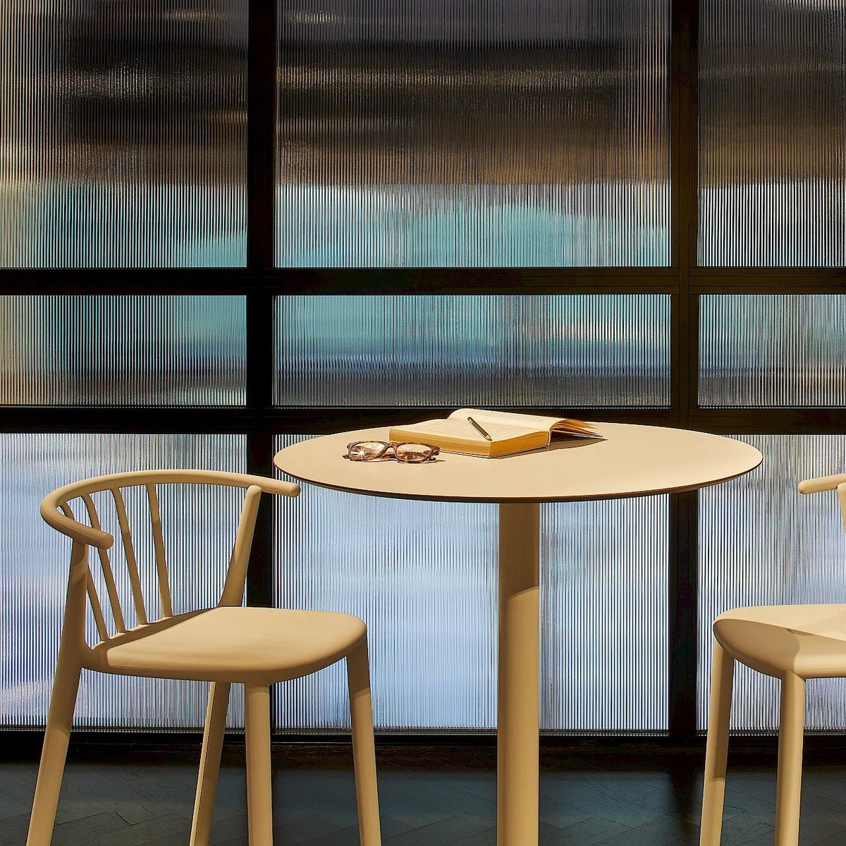 Resol Toledo High Table with Woody bar stools, styled in an interior setting, painted aluminum and HPL