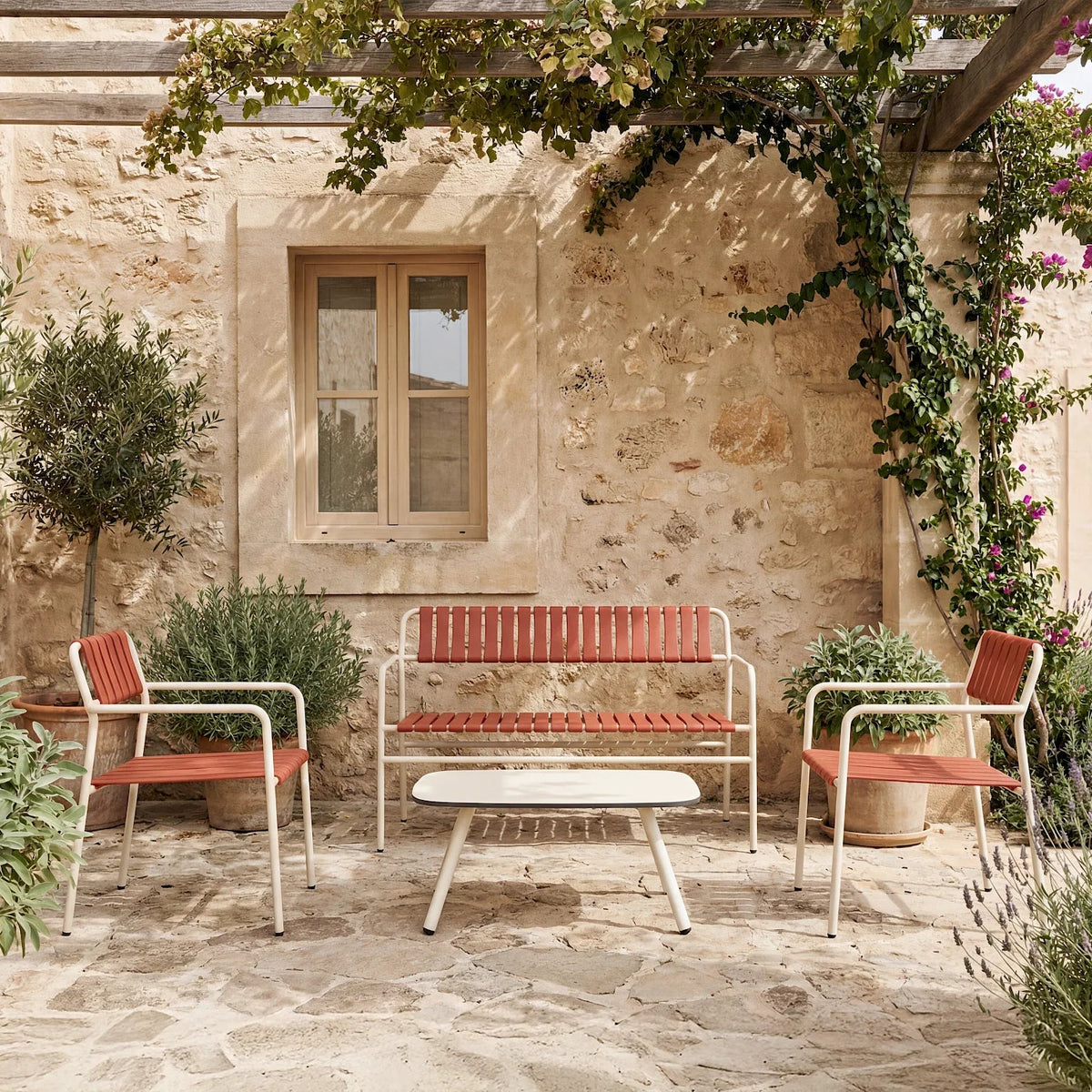 Resol Gelato bench and lounge chairs with Greda terracotta slats on Nácar frames on a stone terrace
