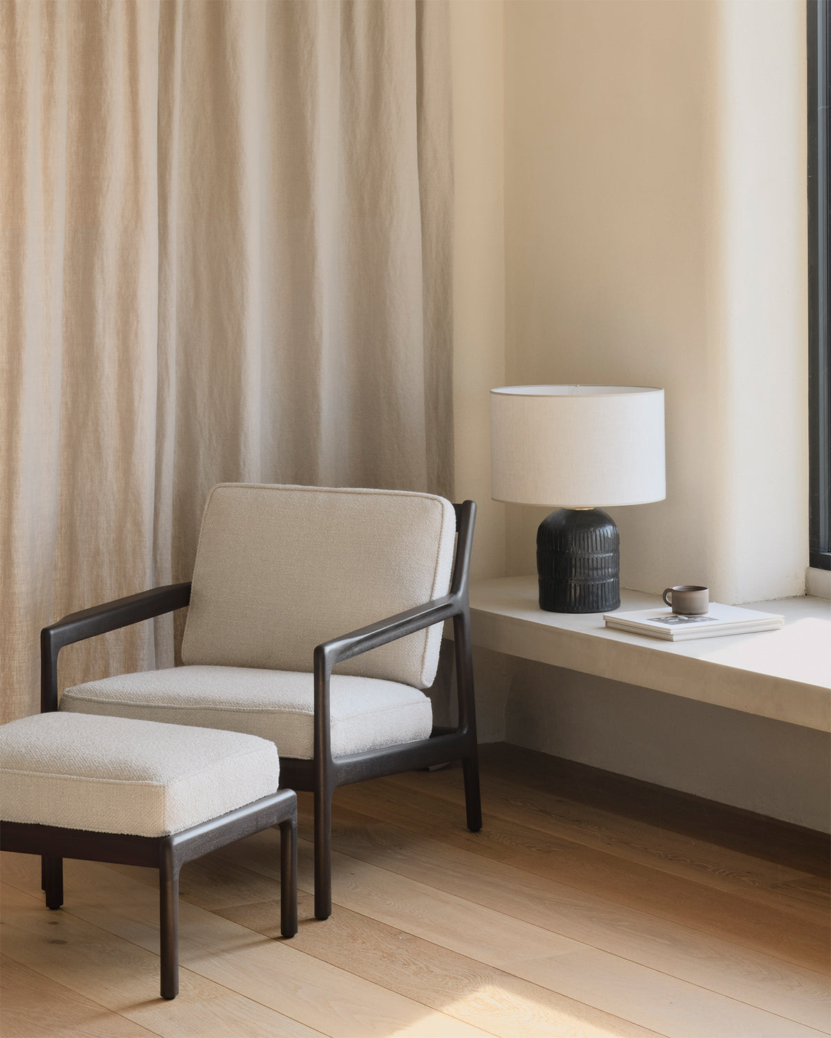 Ethnicraft Jack Footstool in Ivory Fabric with the Jack Lounge Chair, styled in an interior setting, mahogany