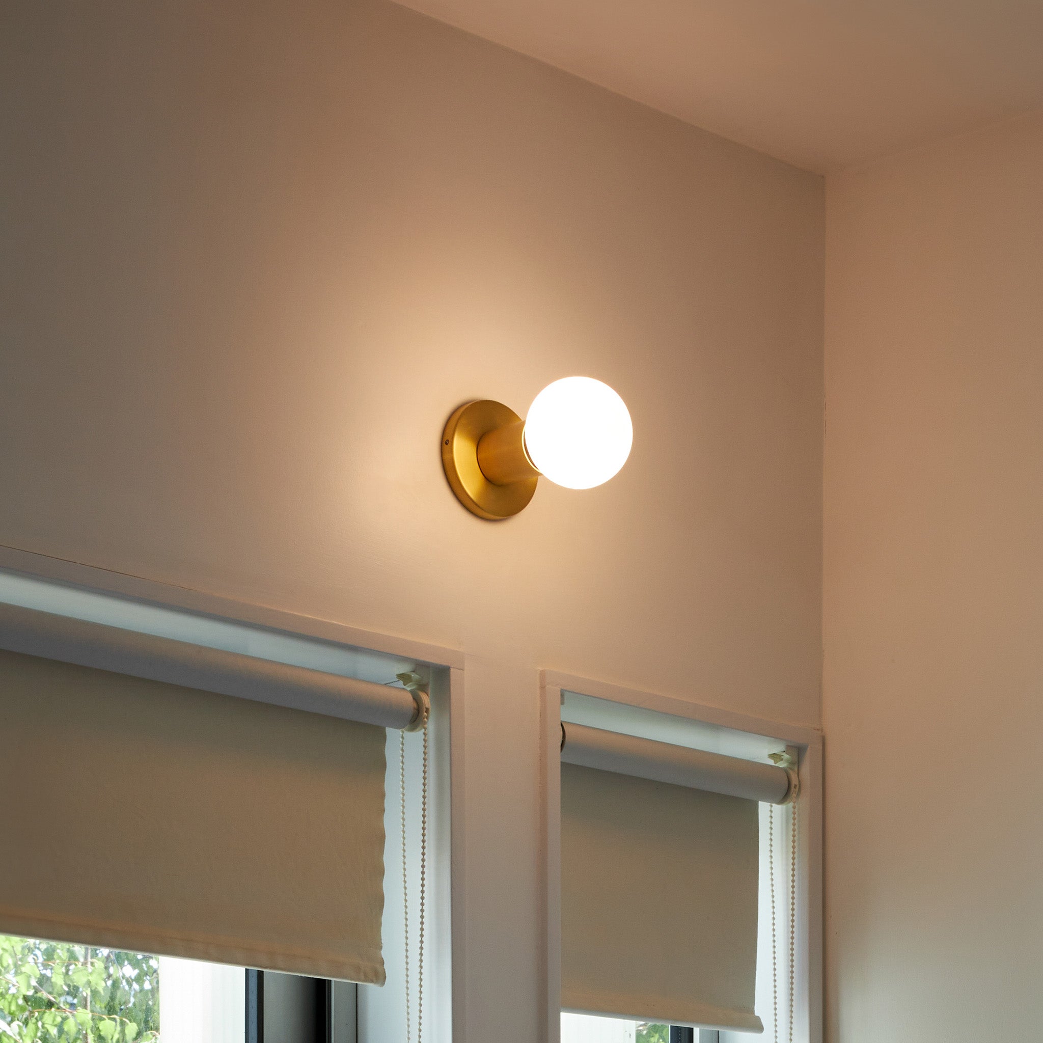 Lochan Wall Light in Brass with Sphere III bulb, lifestyle setting