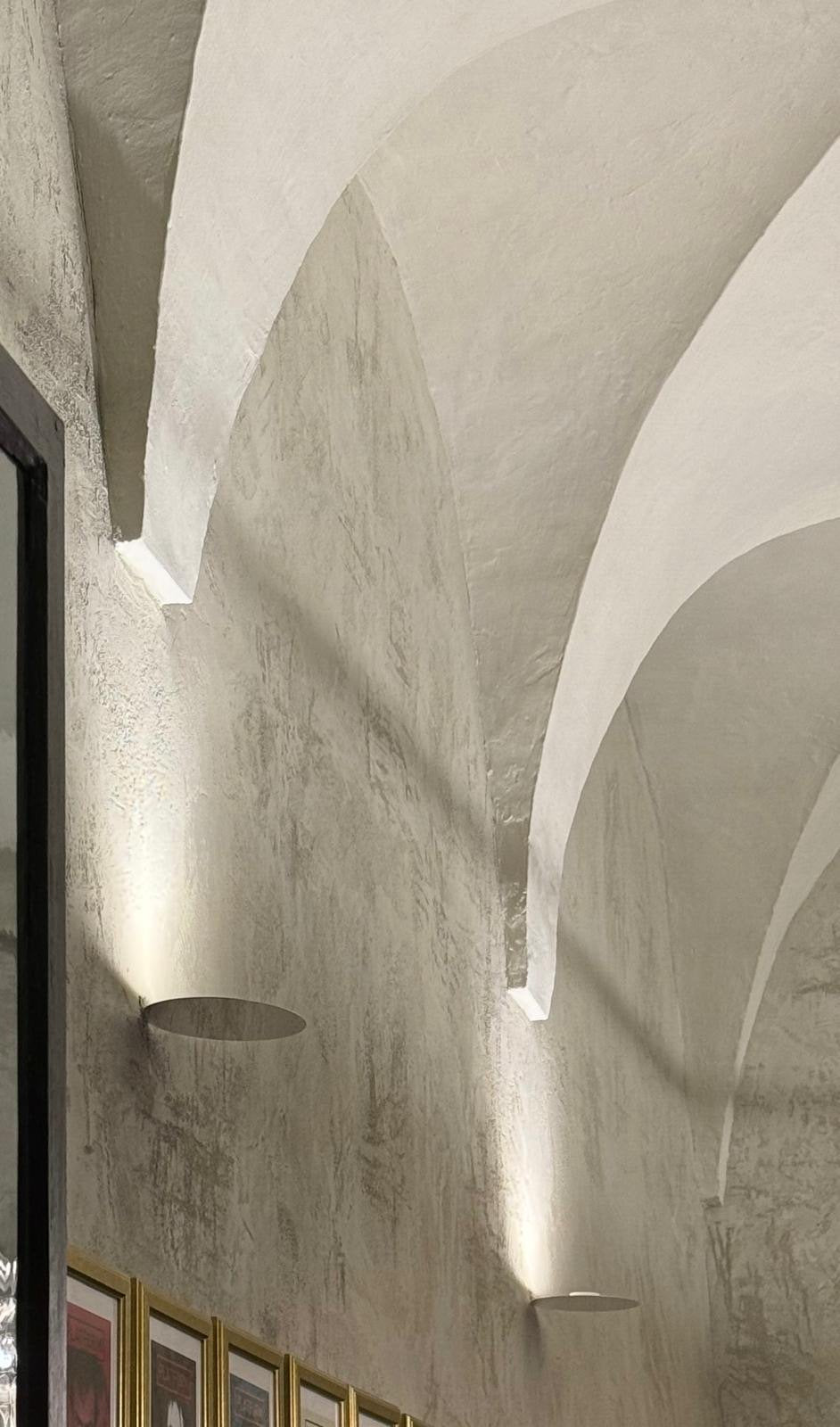 Luceplan Millimetro Wall Lamps washing light up a vaulted plaster wall