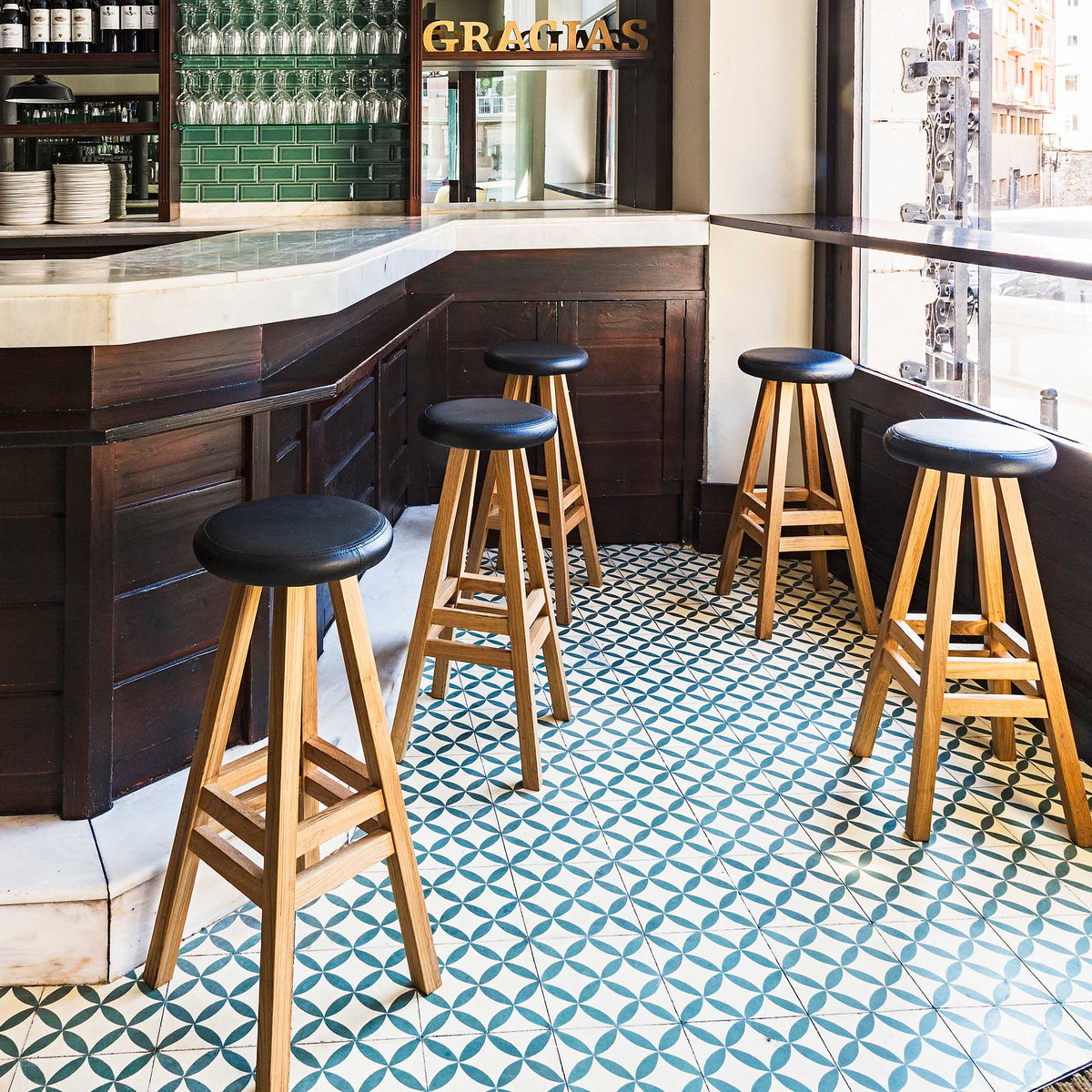 Case Oki-Nami Stools in Oak at a restaurant bar, styled in an interior setting, solid oak