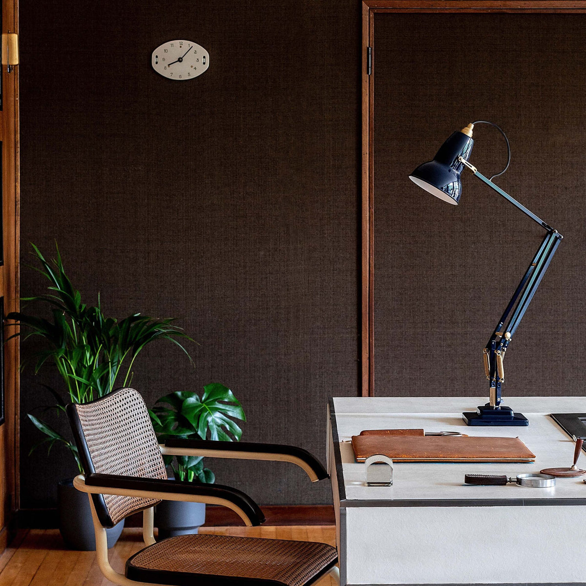 Anglepoise Original 1227 Brass Desk Lamp in Ink Blue, styled in an interior setting, aluminum and brass