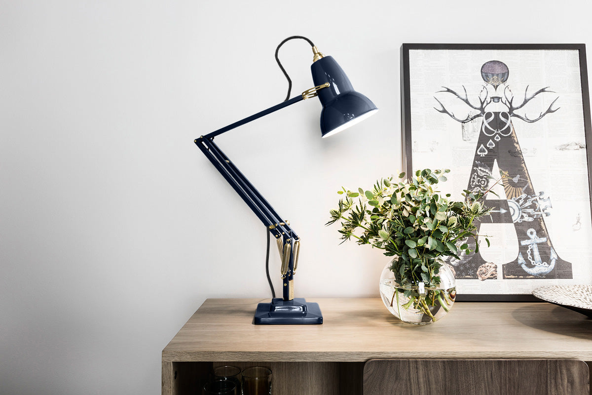 Anglepoise Original 1227 Brass Desk Lamp in Ink Blue, styled in an interior setting, aluminum and brass