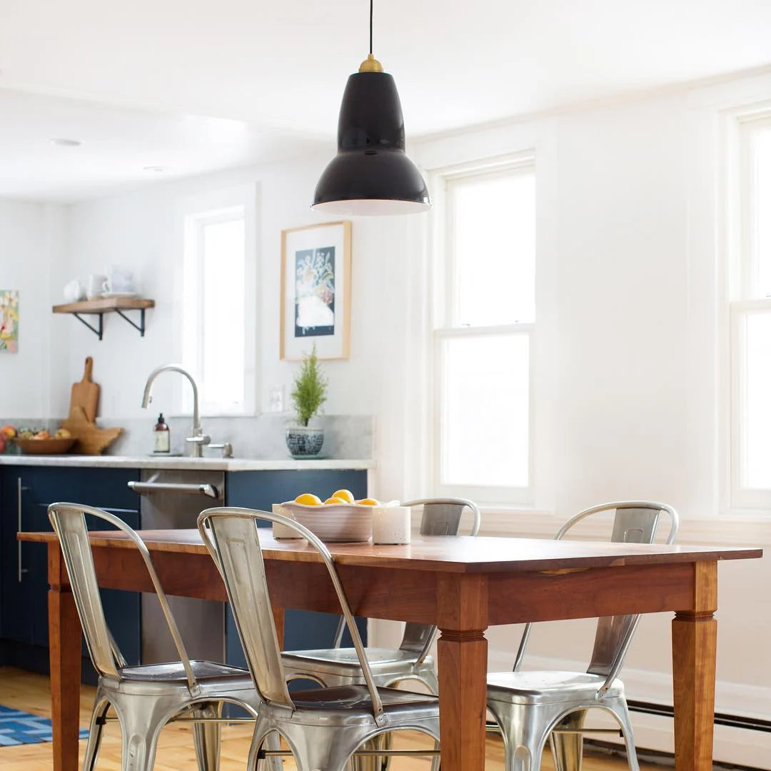 Anglepoise Original 1227 Maxi pendant in Jet Black above a wooden dining table in a kitchen