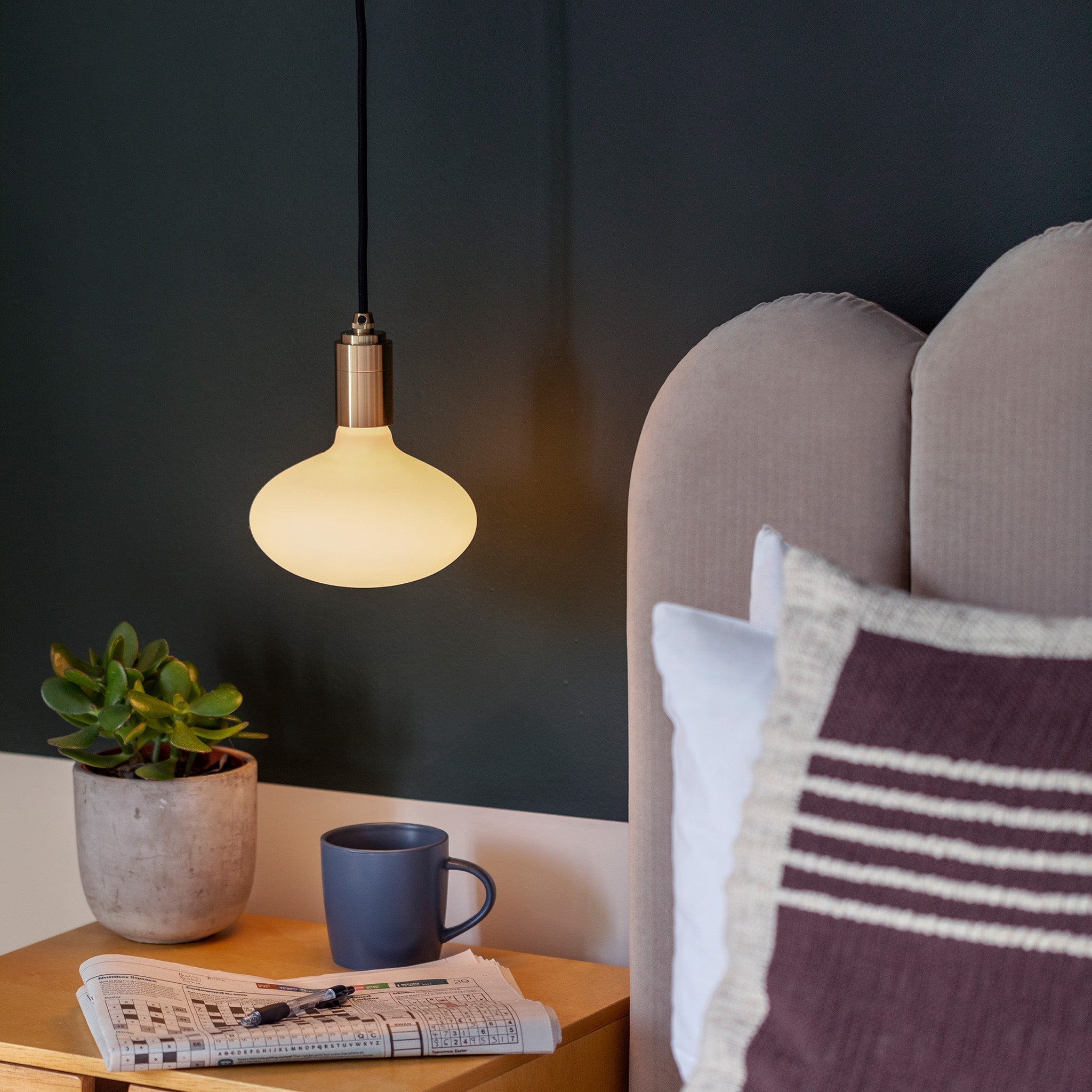 Oval Dim-to-Warm Plug-In Pendant by Tala — lifestyle, bedroom setting, brass