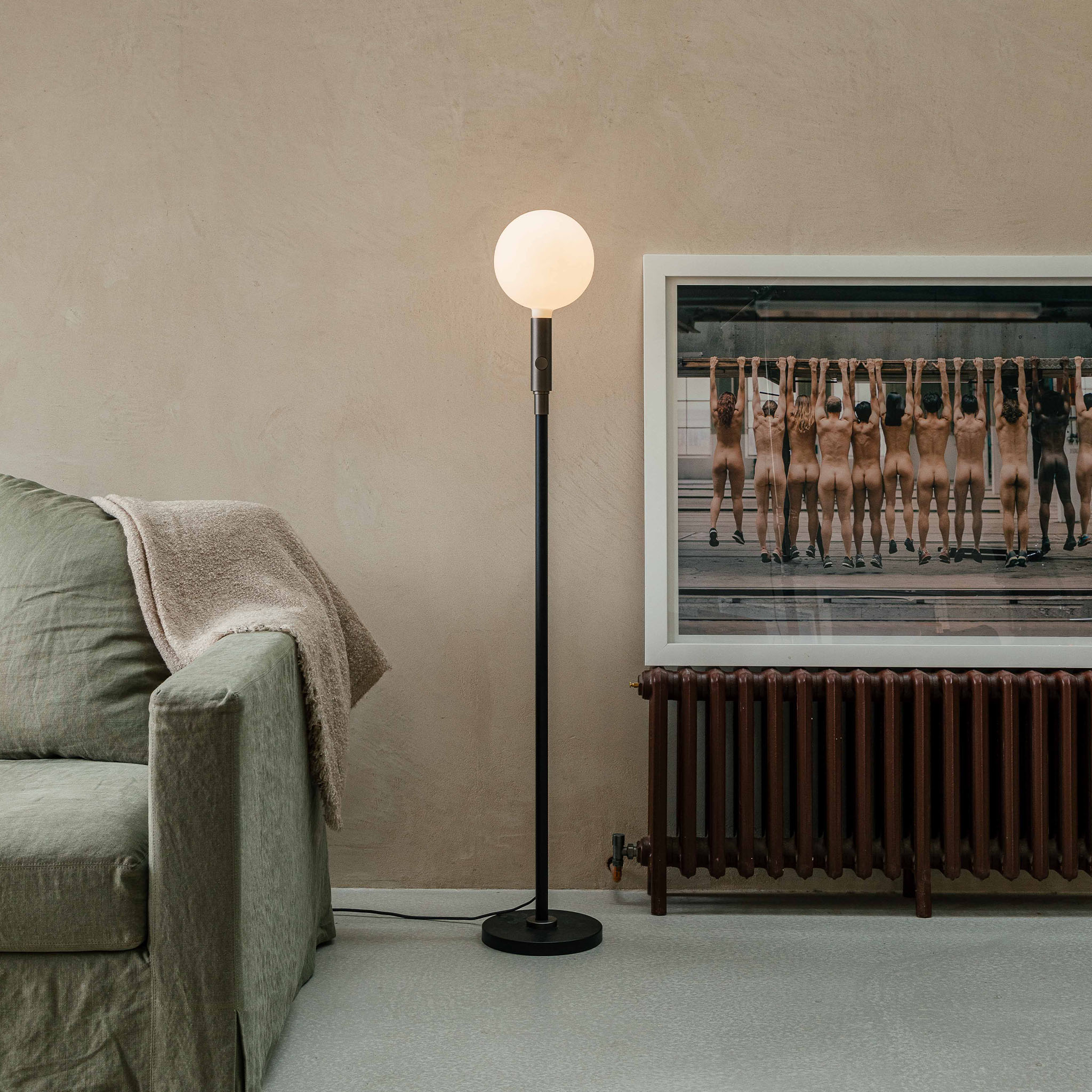 Tala Poise Adjustable Floor Lamp in Graphite, short setting in a living room