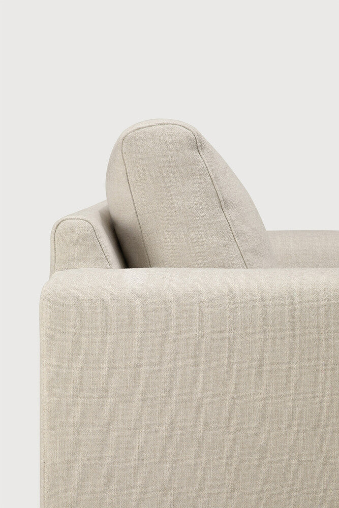 Detail of Ethnicraft Ease Sofa showing the broad upholstered armrest