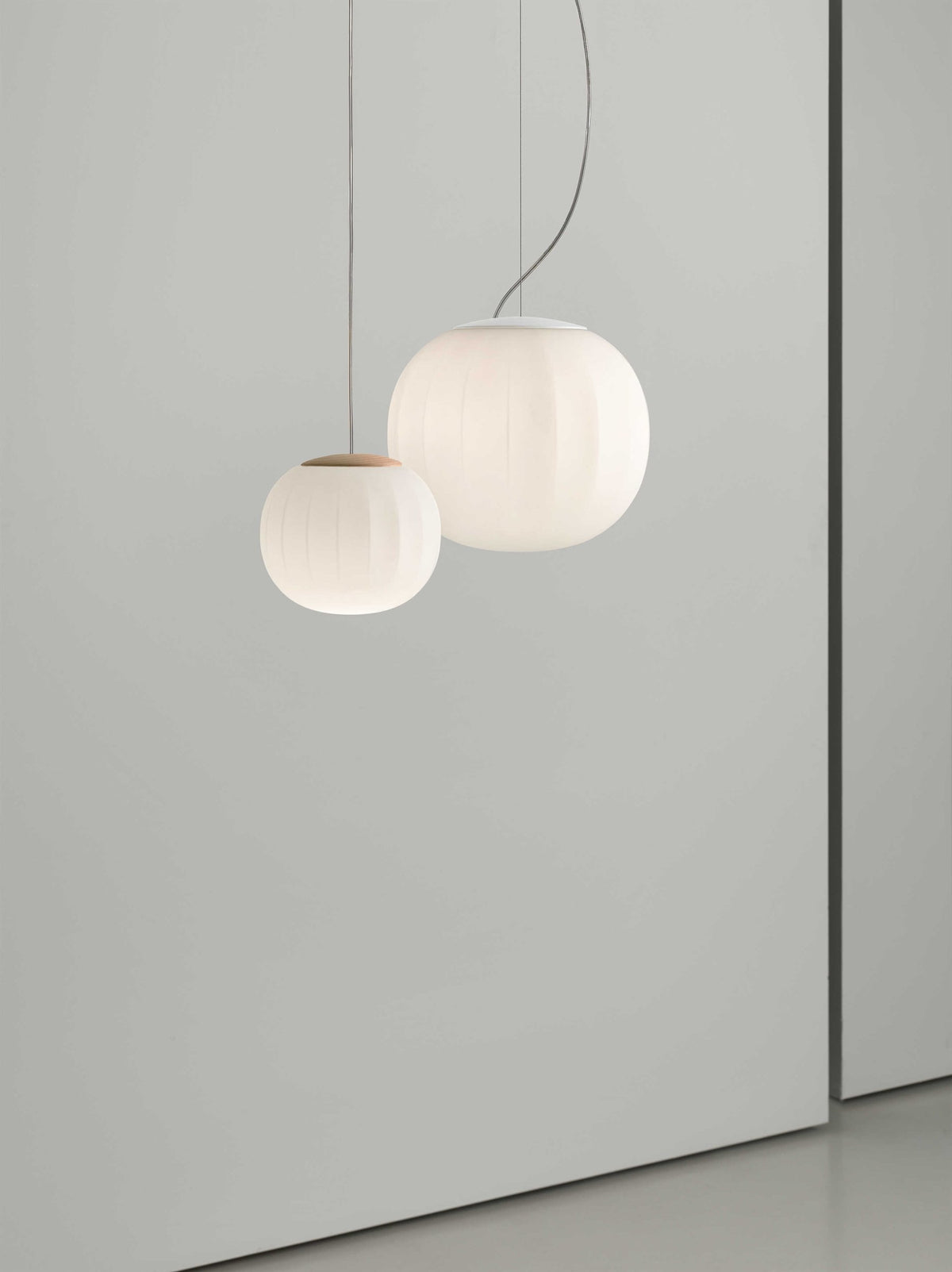 Luceplan Lita Pendants in two sizes, opal glass globes lit