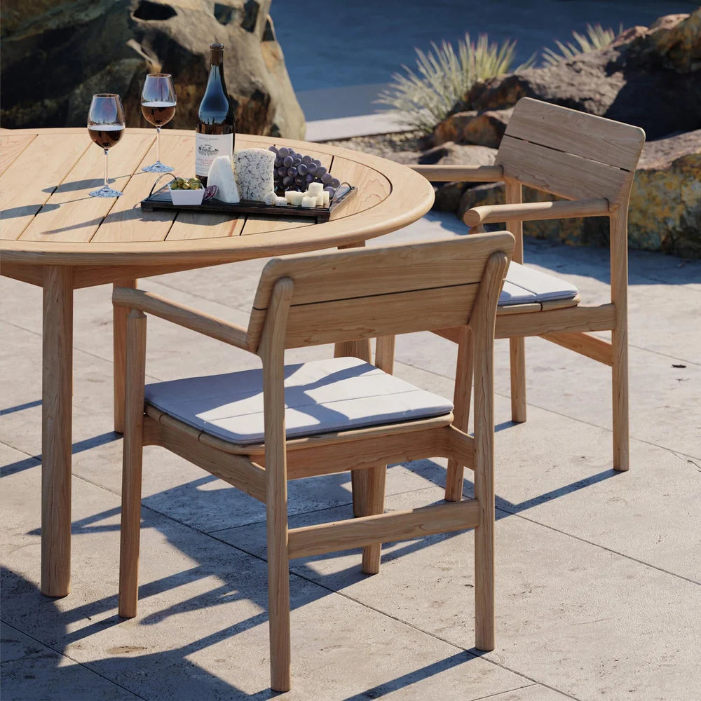 Case Tanso armchairs in teak around a round outdoor dining table