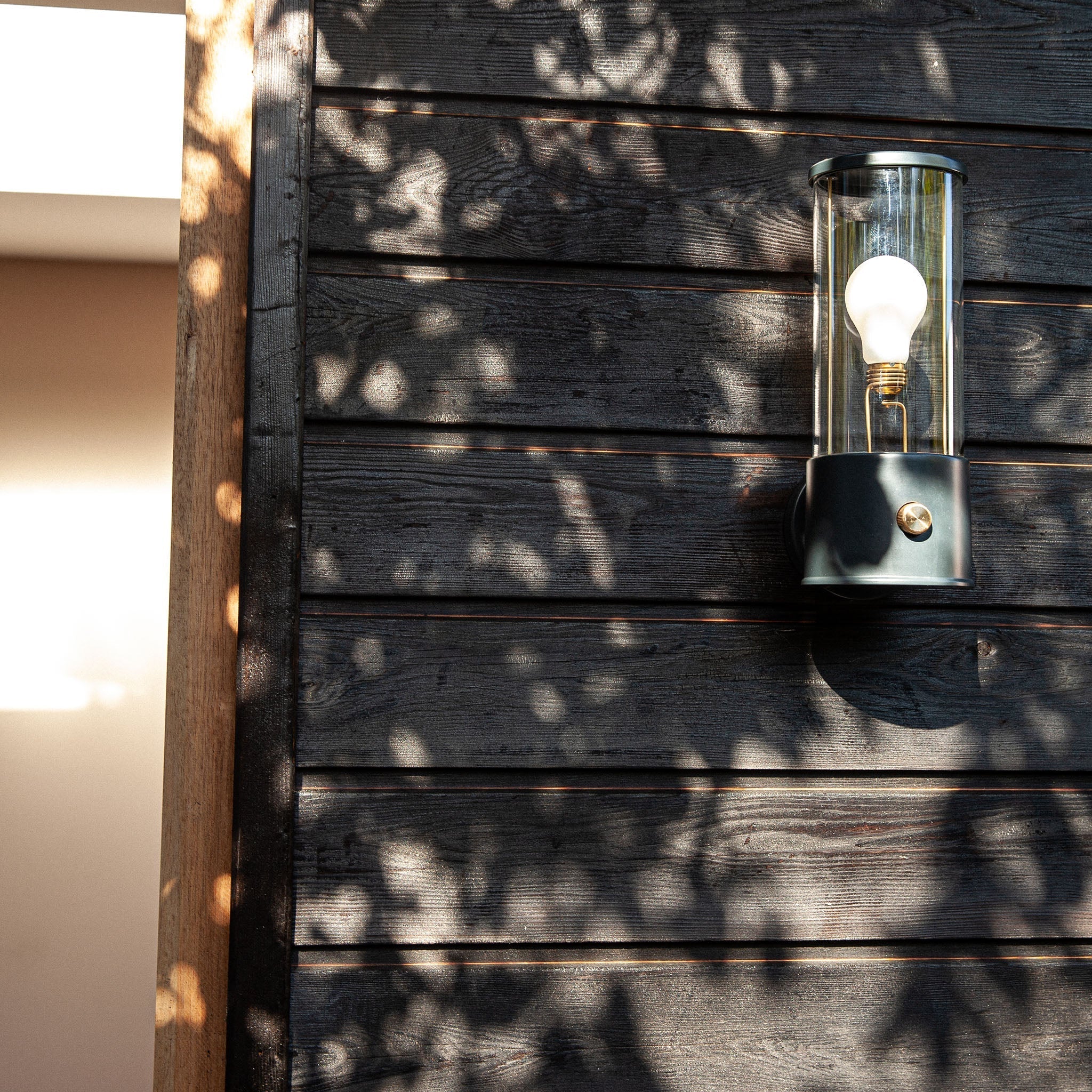 The Muse Wall Light in Hackles Black, wide shot lifestyle