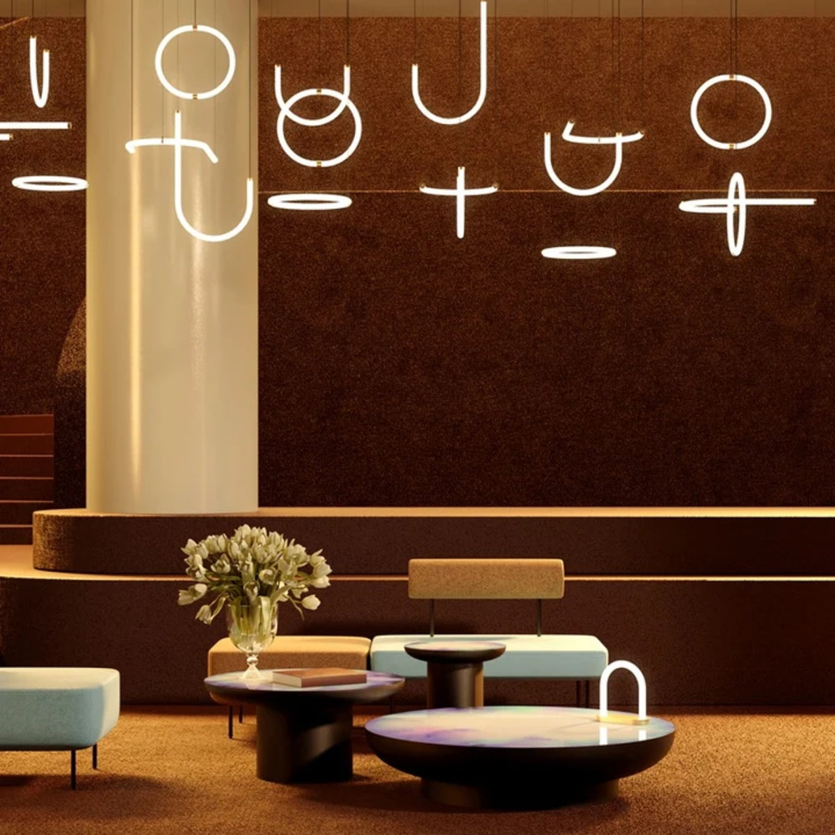 A cluster of Petite Friture Unseen pendant lights above a lounge seating area