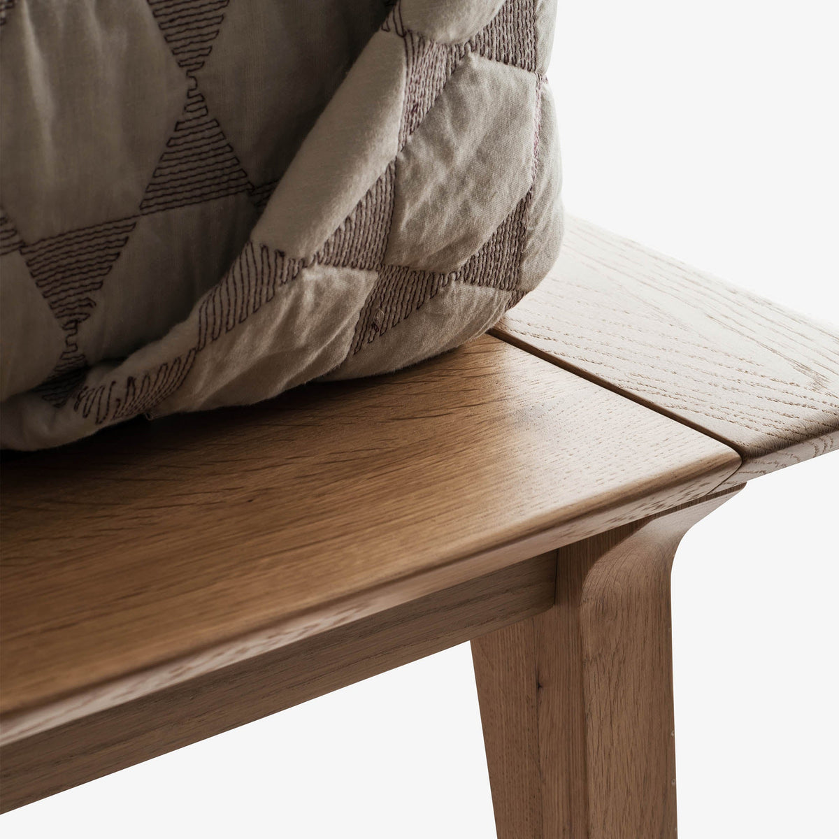 Detail of Case Valentine Bed showing the solid oak frame edge and tapered leg
