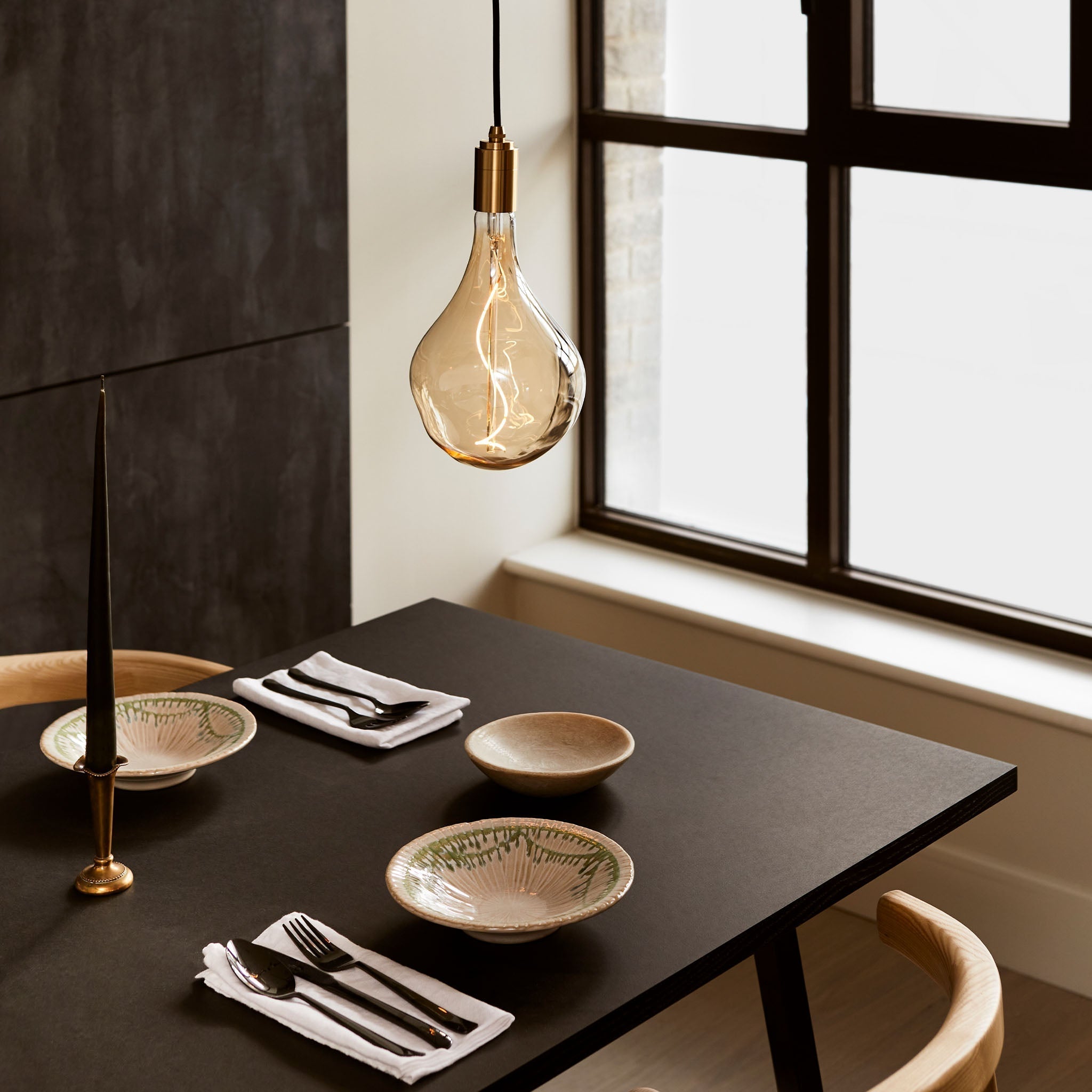 Brass Pendant by Tala over a dining room table