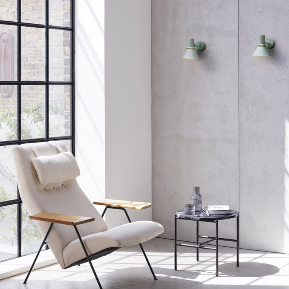 Anglepoise Type 80 wall lights in Pistachio Green above a lounge chair and side table