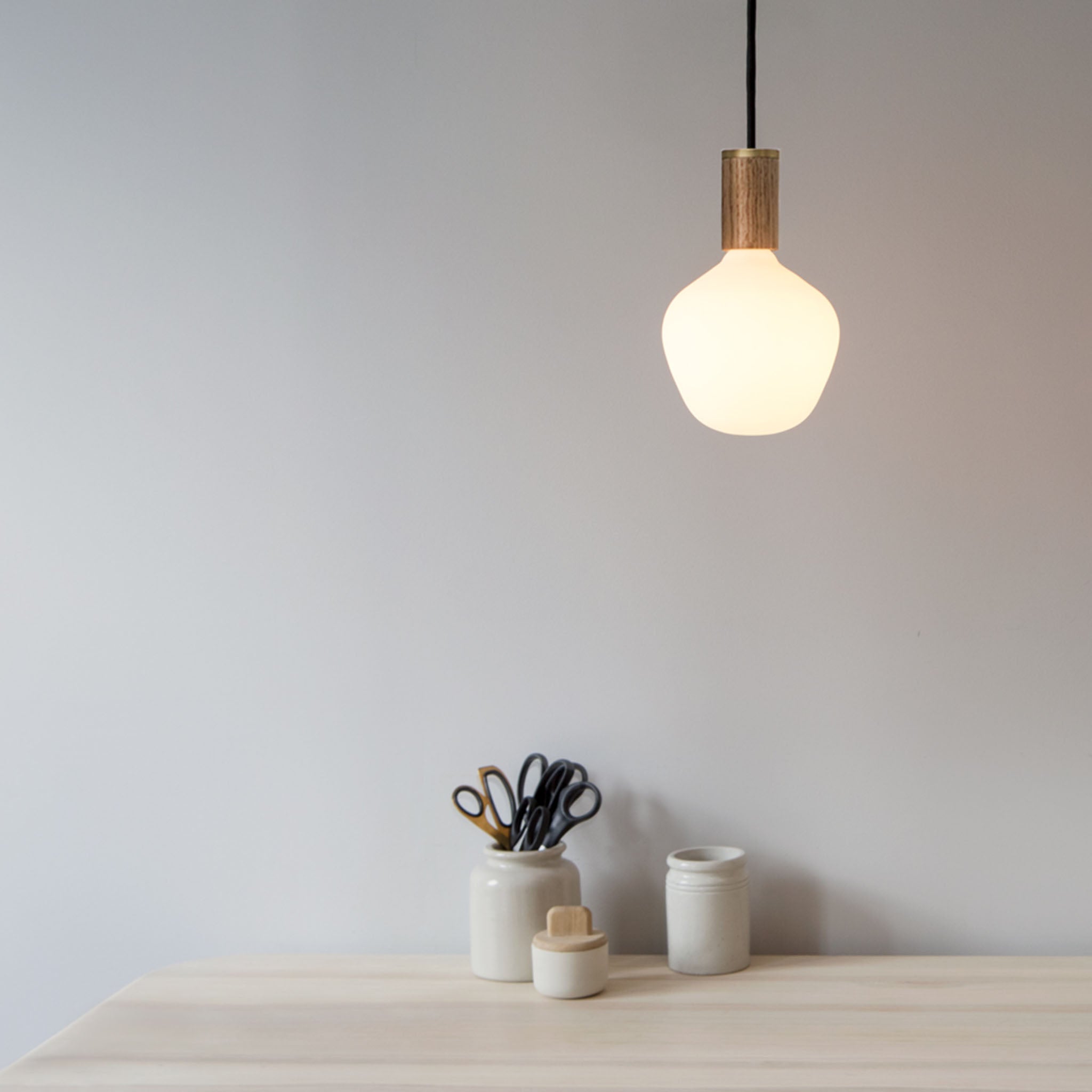 Enno Pendant Light in Walnut, shown above a home office desk