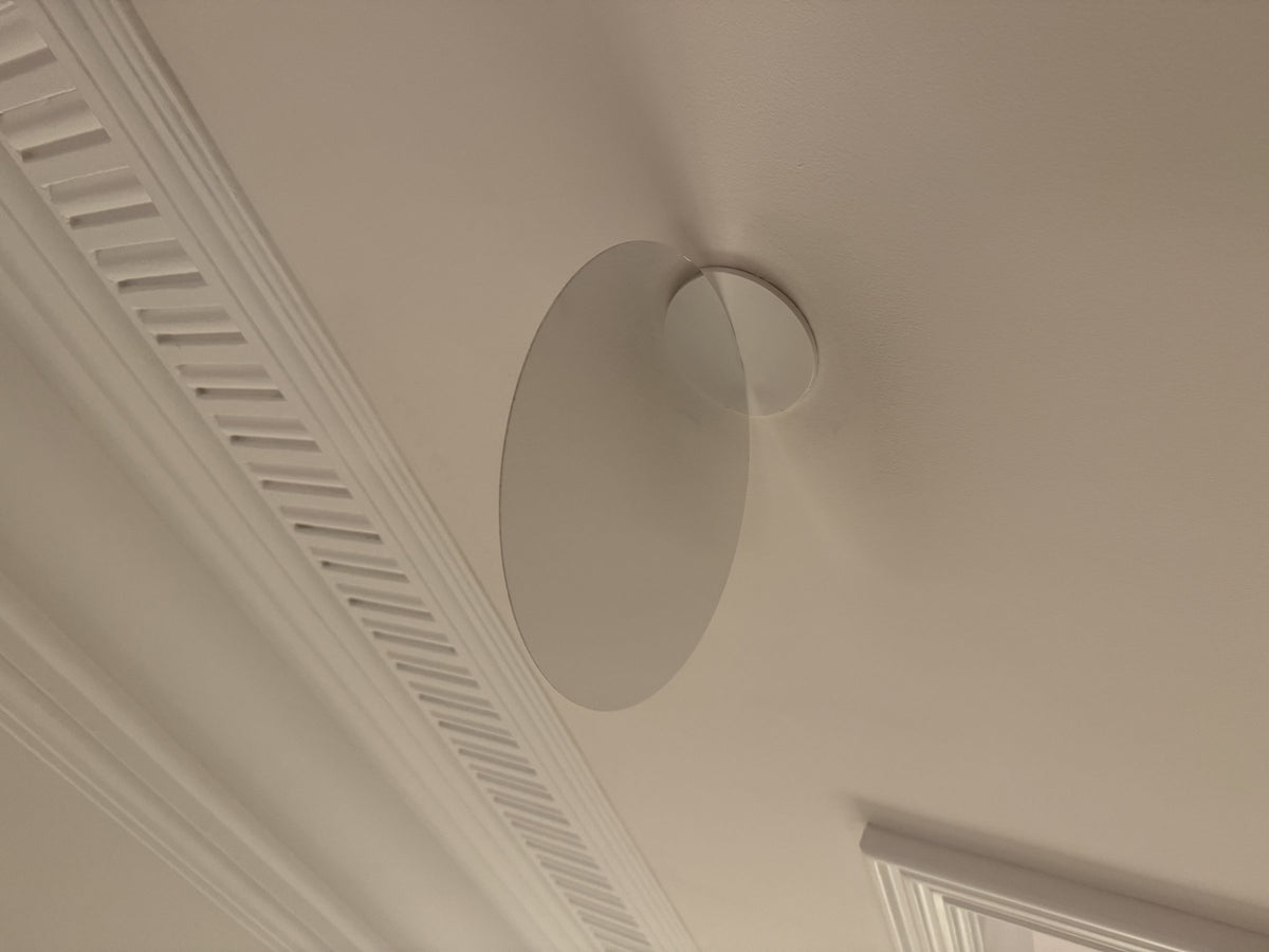 Luceplan Millimetro Wall Lamp disc mounted on a white wall